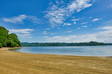 Wide expanse of sandy beach and calm waters near Playa Pajaro in Costa Rica