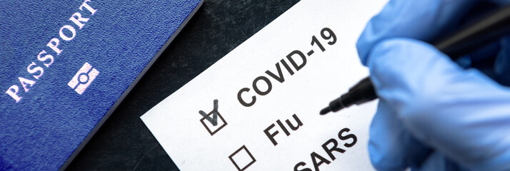 COVID-19 coronavirus pandemic and travel concept, border passport control with COVID19 check.