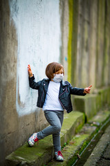 little girl on a walk in a medical mask