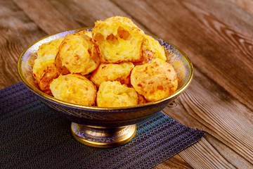 Chewy cheese bread called chipa on wooden table.