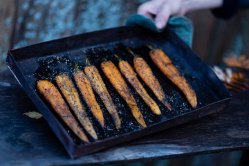 the process of making fresh carrots on a black pan