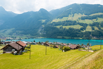 Fototapeta premium View of swiss village Lungern with traditional houses along the lake Lungerersee, canton of Obwalden, Switzerland