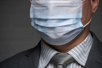 a man puts a mask on his face for antivirus individual protection - healthcare and medicine...