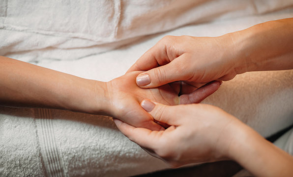 Close up photo of a hand massage session at a professional spa salon