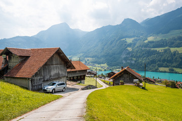 View of swiss village Lungern with traditional houses along the lake Lungerersee, canton of Obwalden, Switzerland. Incredibly bewitching and calm place.