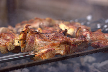 A beautifully toasted piece of pork smokes on the grill