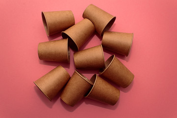 Craft paper cups for coffee or any drinks on a pink paper background. Concept of ziro waste, no plastic