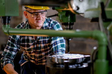 Technician or worker man work with the machine in factory with day light.