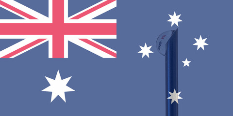 Australian flag and vaccine needle from which a drop of liquid comes out. In the drop. there is a text that says covid-19. Concept of prevention and health care.