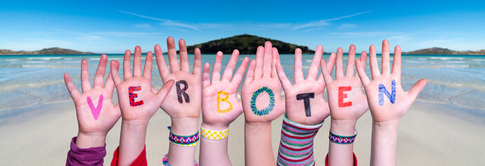Children Hands Building Colorful German Word Verboten Means Forbidden. Ocean And Beach As Background