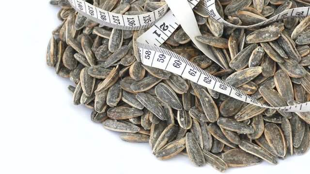 Dry roasted and salted sunflower seeds on 360 rotating stand,