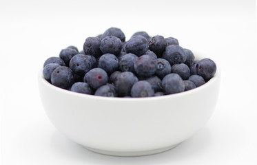 Blueberries in a white bowl on white