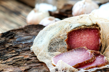 jerky in gauze on a wooden table. homemade organic food without preservatives. pieces of meat with...