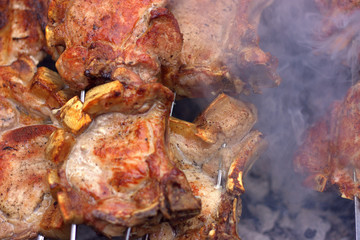 Obraz na płótnie Canvas Gorgeous pork entrecotes smoke on the grill. Beautiful food background
