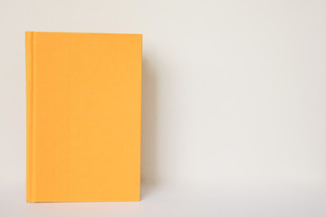 A yellow book isolated on a white background