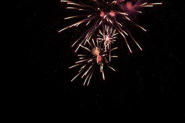 Brightly colorful fireworks and salute of various colors in the night sky background. selective focus