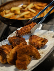 Making chicken schnitzel and french fries in the home kitchen