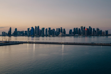 Panoramic view to Doha business center with skyscrapers after sunset