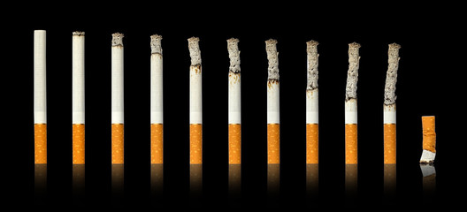 Cigarettes burning and extinguished cigarette black isolated background.