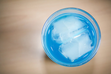View from above in a glass of curaçao with ice cubes