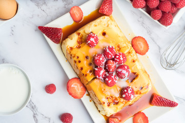 Condensed milk flan with raspberries and strawberries.