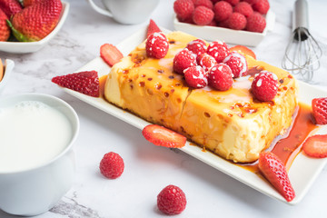 Condensed milk flan with raspberries and strawberries.