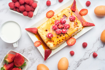 Condensed milk flan with raspberries and strawberries.