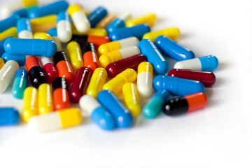 Colorful medicine capsules, antibiotic and drug pills on white background, isolate, close up