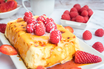 Condensed milk flan with raspberries and strawberries.