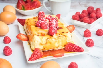 Condensed milk flan with raspberries and strawberries.