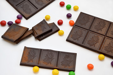  sweets pieces of chocolate and colored dragees on a white background