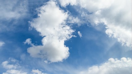 Scenic blue sky with beautiful white clouds. Clouds floating on blue sky, 16:9 panoramic format