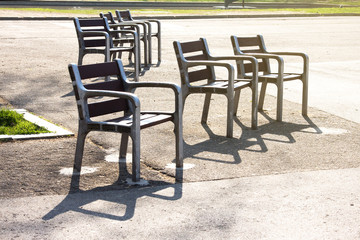 Empty chairs in the morning sunlight. City Park. Barcelona, Spain.