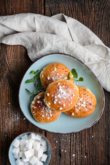 Bath buns, classic English sweet pastry glazed with syrup, topped with caraway seeds and crushed sugar cubes