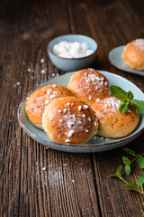 Bath buns, classic English sweet pastry glazed with syrup, topped with caraway seeds and crushed sugar cubes