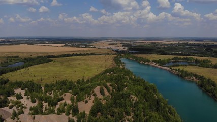 Beauty aerial footage of hills and cristal blue lake. Nice footage of old career with nice lakes