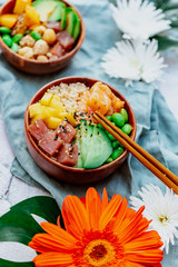 Salmon poke with avocado, seaweed, pickled carrots and cucumber