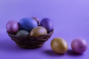 Easter basket with colorful eggs on a gray background