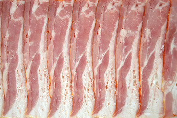 slices of raw meat  sliced ​​bacon closeup texture background