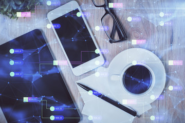 Double exposure of technology theme drawing over work table desktop. Top view. Global data analysis concept.