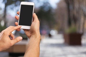 Human hand holding smartphone with empty screen