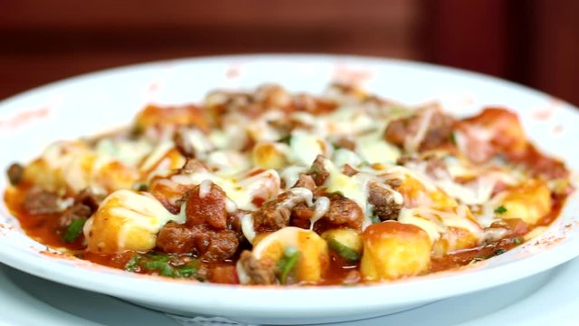 Gnocchi with al Rag&ugrave; sauce, cherry tomatoes and melted grated cheese