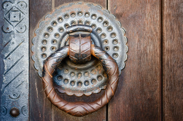 Antique iron knocker on a medieval church door