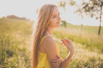 Portrait of young, pretty  woman outdoor on a summer sunny day