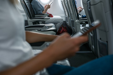 Passengers in abord a commercial flight using their cell phones during flight