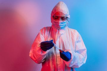 Test tube with blood sample. Scientist with biohazard protection cloth and glove for protection