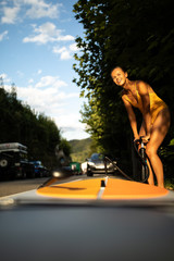 Obraz premium SUP Stand up paddle board concept - Pretty, young woman paddle boarding on a lovely lake in warm late afternoon light - shot from underwater