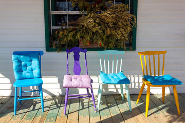 colorful chairs on white Mediterranean style terrace front deck rural exterior