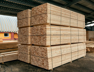Packed boards, lumber piles in the finished goods warehouse - obrazy, fototapety, plakaty