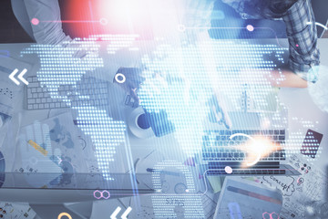 Double exposure of man and woman working together and world map hologram drawing. international network concept. Computer background. Top View.